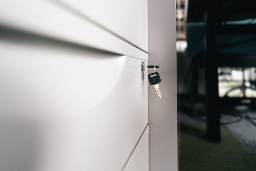 Close-up of a key in a locked office drawer, symbolizing secure storage and privacy
