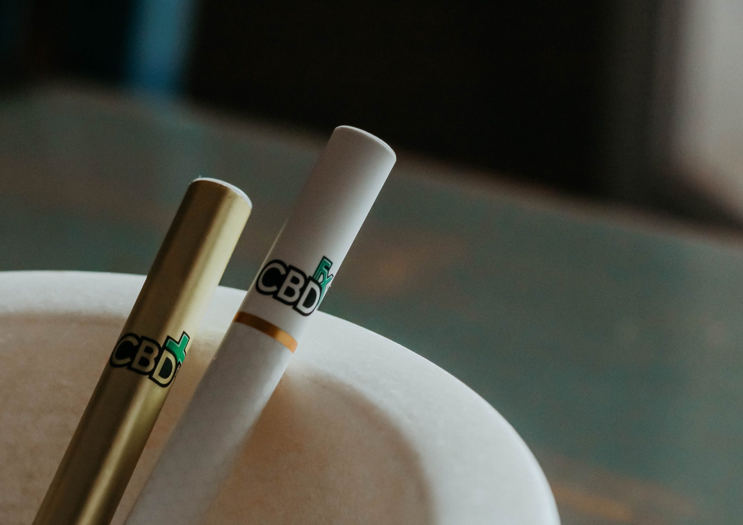 Close-up of CBD cannabis vape pens resting in an elegant ashtray