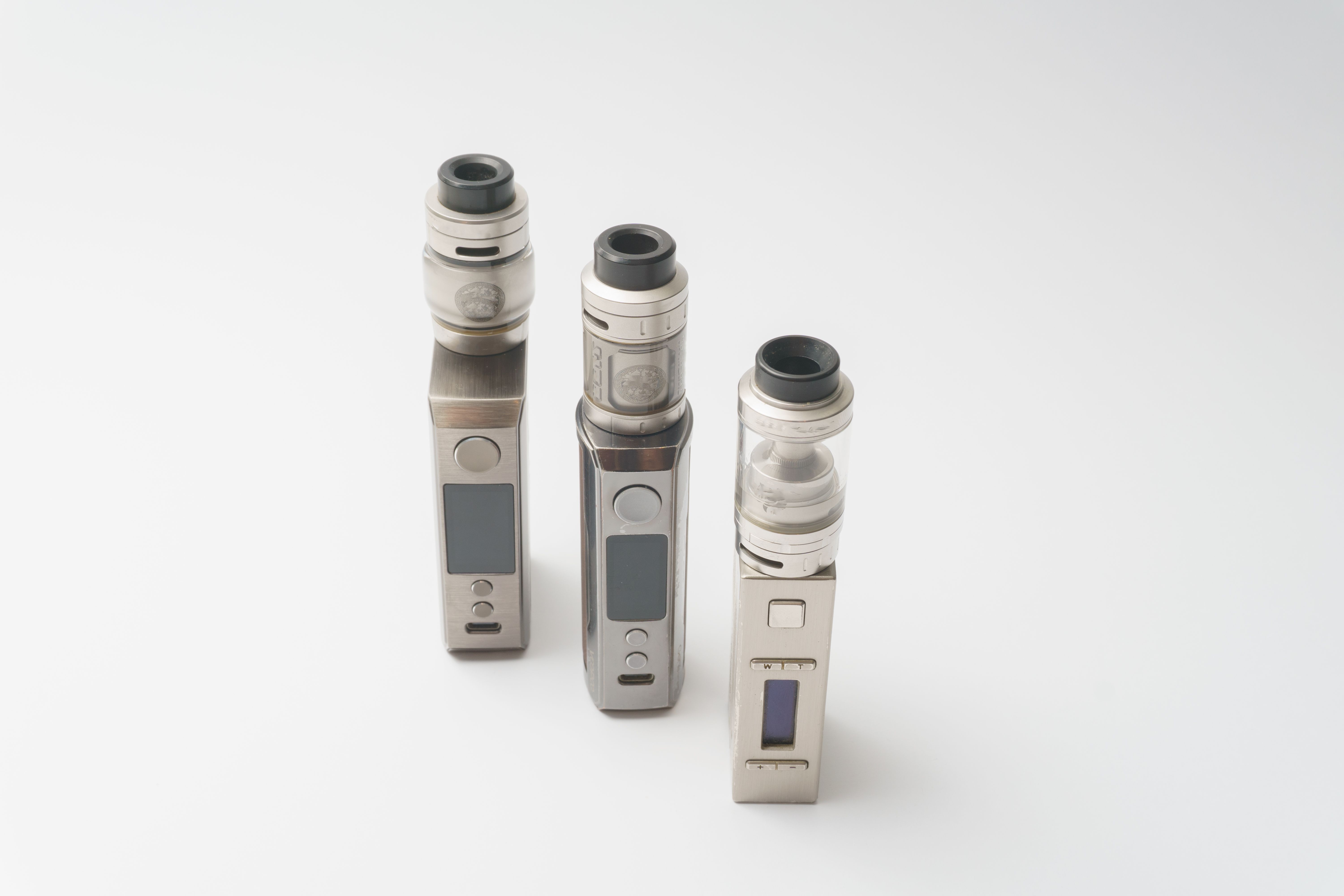 Three sleek vape devices displayed on a white background showing product lineup variety